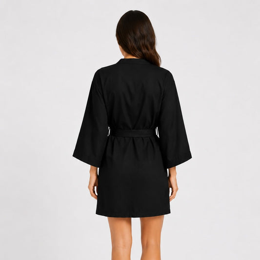 Woman wearing a black Tencel robe on a white background