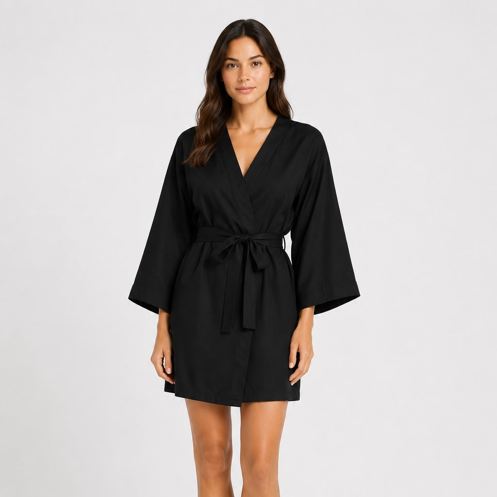 Woman wearing a black Tencel robe on a white background